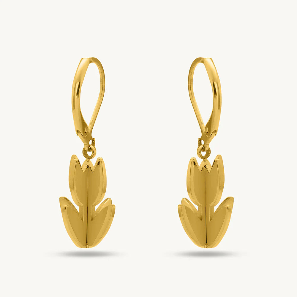 Gold tulip-shaped earrings on a light gray background