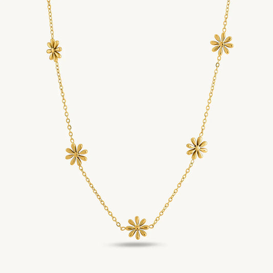 Gold necklace with floral pendants on a white background